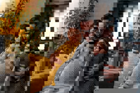 Family covered in blanket