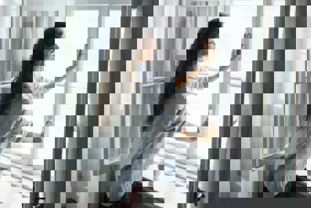 Woman closing the window